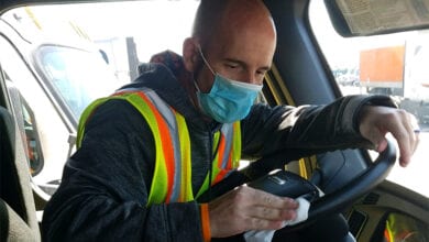 truck driver with mask cleaning truck