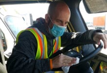 truck driver with mask cleaning truck